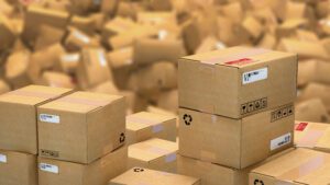 Stacked shipping boxes amidst a pile of shipping boxes.